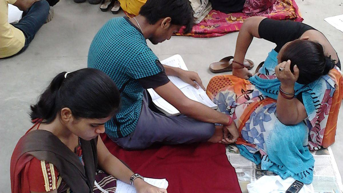 Students revising their notes outside an exam centre just before the paper